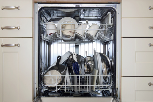 Close-up of a dishwasher with cleaned dishes inside