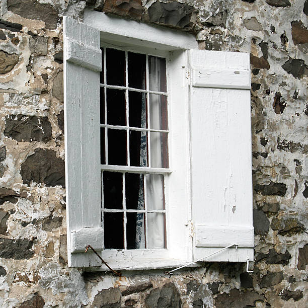 istock 17th Century shuttered window in stone house 172710811