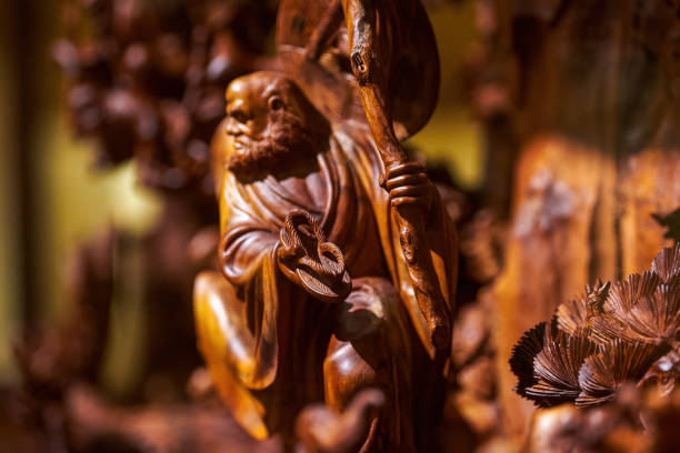 Close-up of exquisite Buddhist mahogany Buddha statue Close-up of exquisite Buddhist mahogany Buddha statue antique chinese dolls pictures stock pictures, royalty-free photos & images