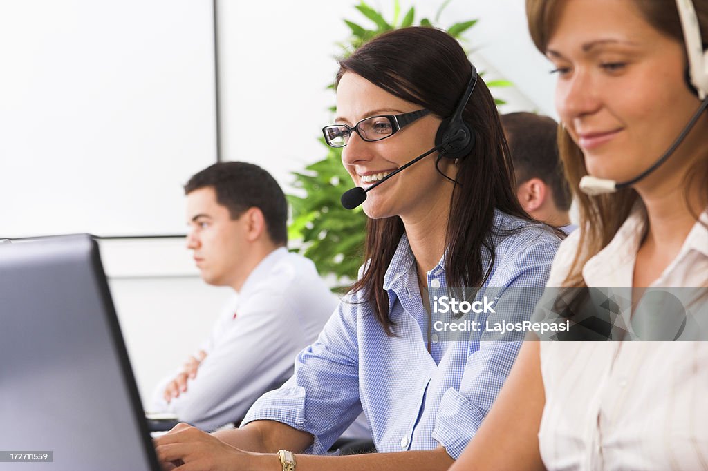 Young friendly female helpdesk operator Customer Stock Photo