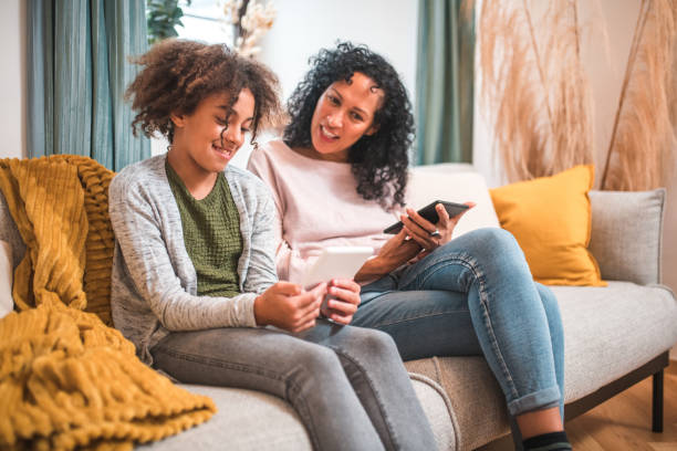 istock Cozy Sofa Reading: Hispanic Mother and Mixed Race Daughter 1727118300