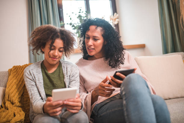 istock Technology and Togetherness: Hispanic Mother and Mixed Race Daughter 1727118301