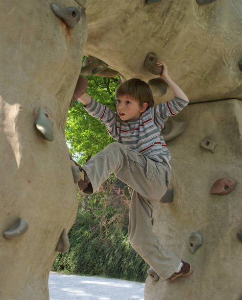 istock Boy hanging on a climbing wall 172711847
