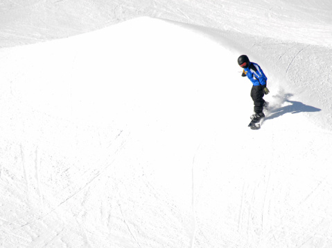 Snowboarder tackles the contours of a mountainside in Colorado