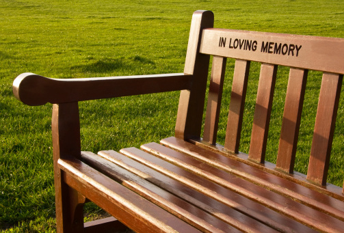 A park bench inscribed \