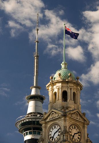 The traditional, stonebuilt Auckland Town Hall in the foreground, with the modern Sky Tower, the tallest building in the southern hemisphere, in the background.