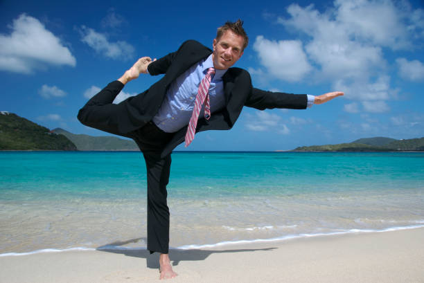 istock Businessman in Full Suit Doing Yoga Stretch on Tropical Beach 172713105