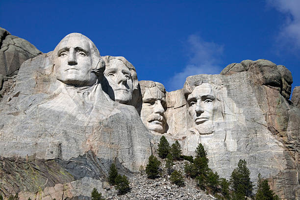 Mount Rushmore Close up view of Mount Rushmore under a blue sky presidents day stock pictures, royalty-free photos & images