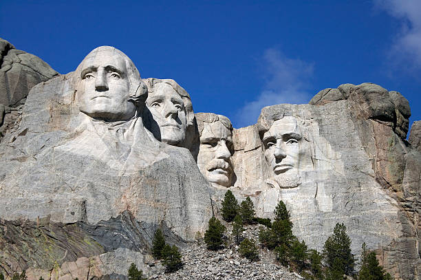 Mount Rushmore Close up view of Mount Rushmore under a blue sky presidents day weekend stock pictures, royalty-free photos & images