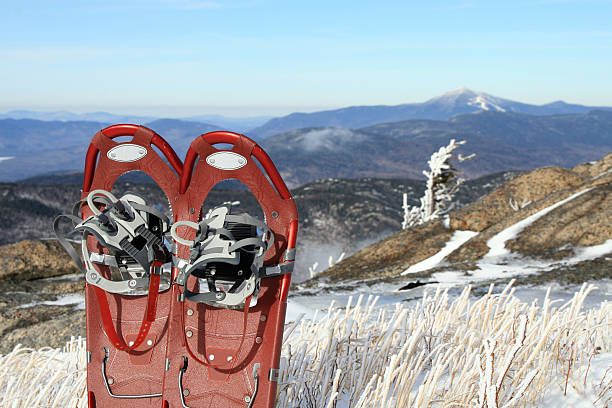 Pair of Red Snowshoes on a Mountain Summit Hi Tech Snowshoes, and Whiteface mountain behind whiteface mountain stock pictures, royalty-free photos & images
