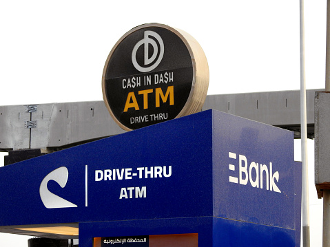 Cairo, Egypt, October 8 2023: Automated Teller Machine drive-thru lanes providing access to ATMs using an automobile, Cash in Dash ATM with many banks like National bank of Egypt, Misr Banque and CIB, selective focus