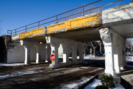 Brutalist architecture style example, low angle view of large concrete overpass bridge, selective focus