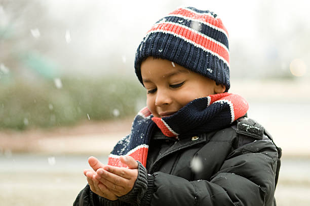 catching snow Outside playing with snow flurries kids winter coat stock pictures, royalty-free photos & images