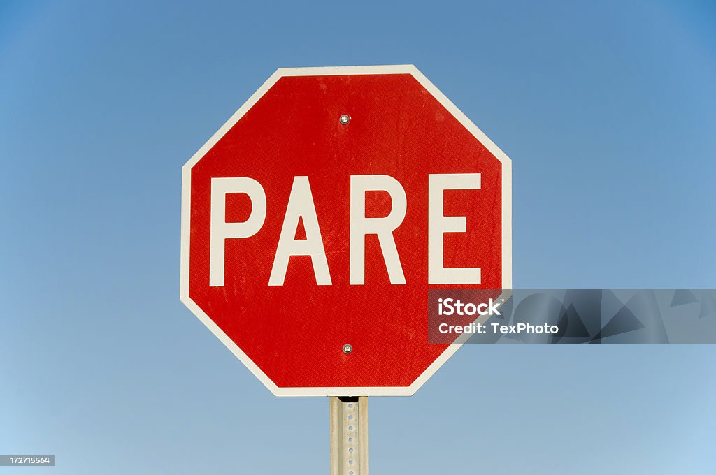 PARE! spanish stop sign A Spanish Language stop sign. Sign Stock Photo