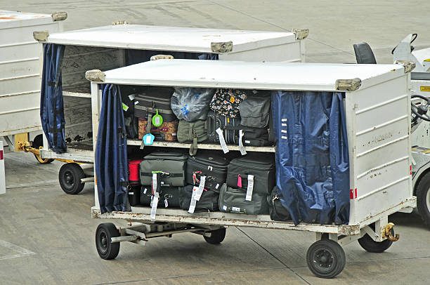 Baggage cart awaiting loading into aircraft hold,