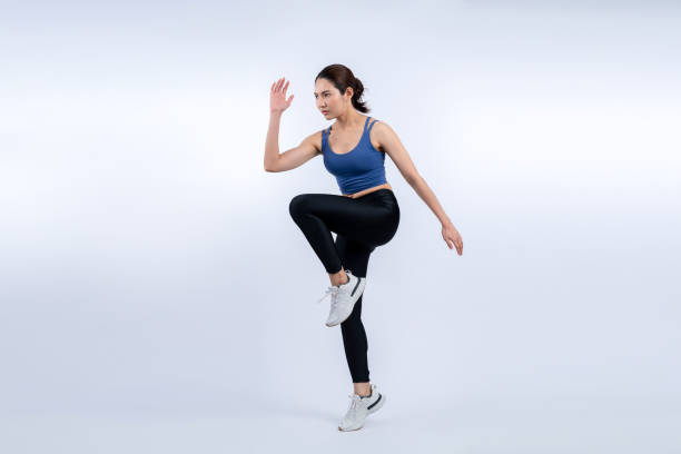 istock Side view young athletic asian woman on running posture. Vigorous 1727165542