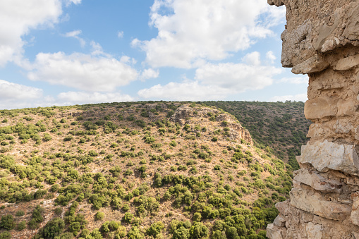 View of adjacent passage between hills from fortress wall of ruins of residence of Grand Masters of Teutonic Order in ruins of castle of Crusader fortress located in Upper Galilee in northern Israel