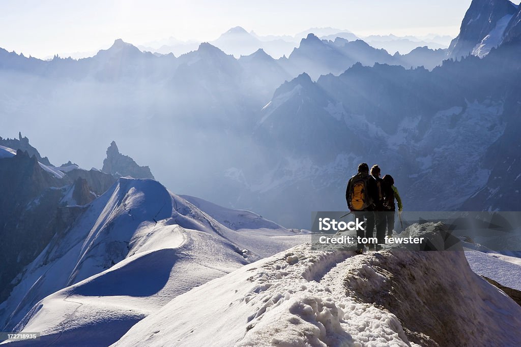 Climbers on mountain ridge Climber decending a mountain ridge near Chamonix, French Alps Leading Stock Photo