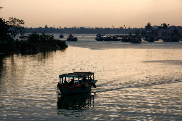 Sunset at Thu Bon river "Sunset at Thu Bon river in Hoi An, Vietnam." thu bon river stock pictures, royalty-free photos & images