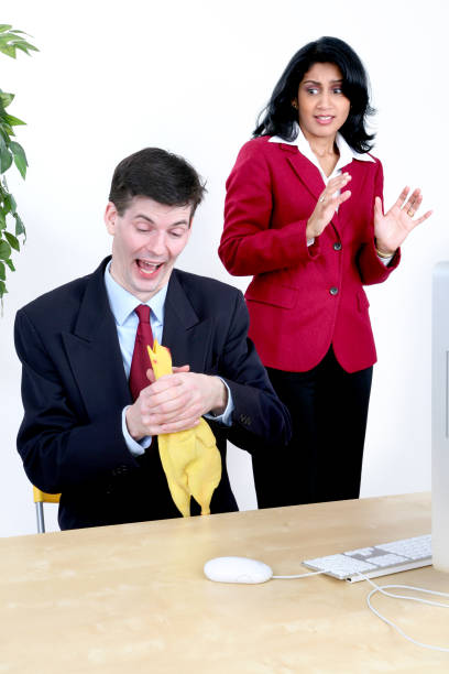 Chocking the Chicken A Business Man is caught slacking off at work by a coworker. Just for fun. lol. woman strangles man stock pictures, royalty-free photos & images