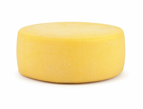 Wheel of big cheese isolated on white. Clipping path included to remove shadow or place object on your background.