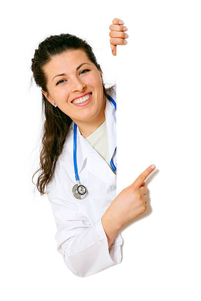 Female doctor pointing to black sign stock photo