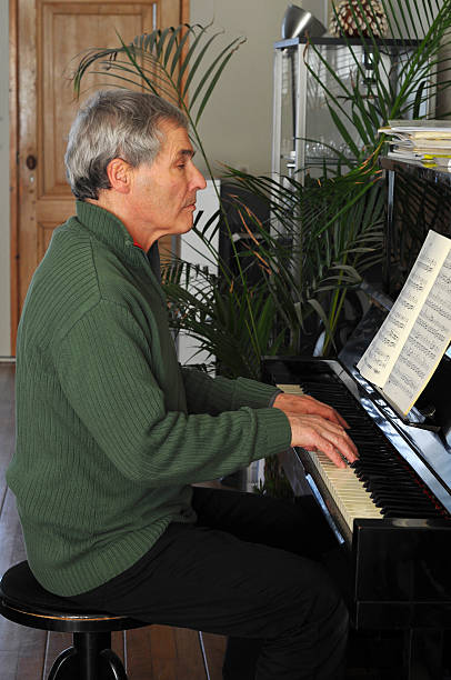 istock senior man  playing the piano. 172720302