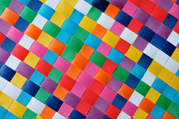 Checkerboard Diagonal Multicolored woven checkerboard.   FOR MORE BACKGROUNDS (CLICK woven place mat multi colored checked stock pictures, royalty-free photos & images