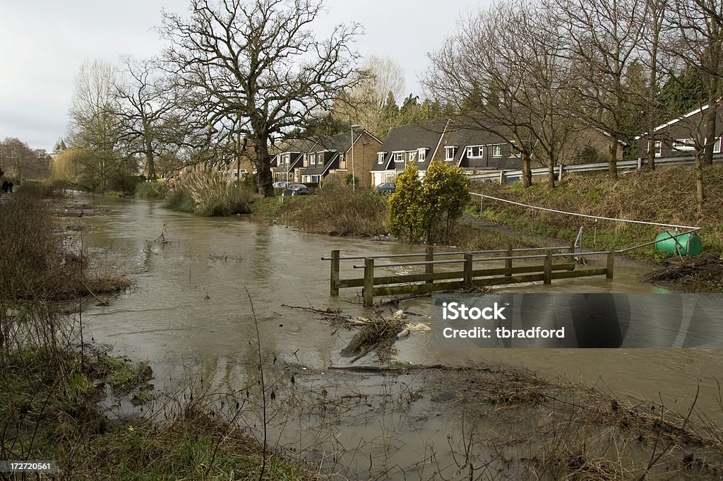 Flooding River Bursts It's Banks In Gloucestershire, England A River In Gloucestershire Bursts It's Banks And Flows Over The Footbridge Flood Stock Photo
