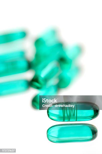 Prescription Drugs Advil On Reflective Surface Stock Photo - Download Image Now - Beauty, Capsule - Medicine, Cut Out