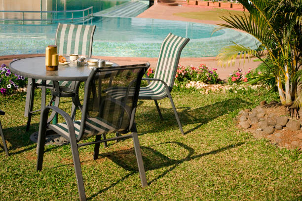 istock Formal Garden chairs table in front of Swimming Pool 172722035