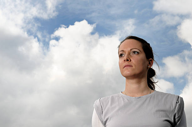 istock young woman and cloudy sky 172722214