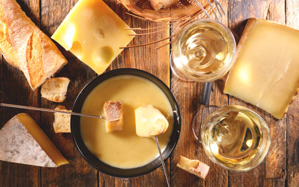 istock cheese fondue, bread and white wine glasses 1727225771