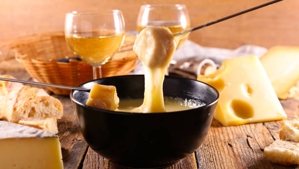 istock cheese fondue, bread and white wine glasses 1727227805