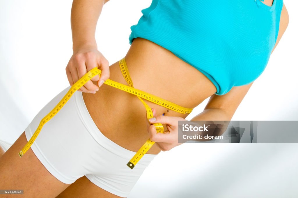 Measuring measuring tape around womans waist Concepts Stock Photo