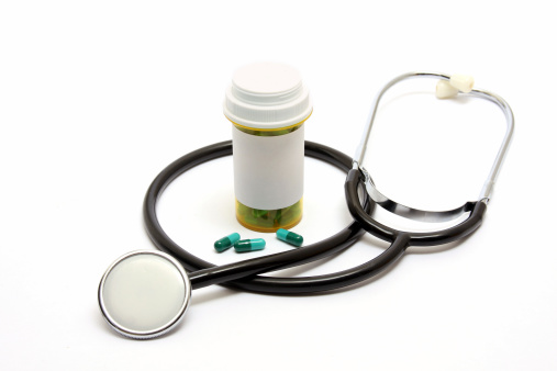 A stethoscope and pill bottle.
