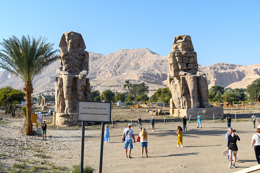 Luxor, Egypt - December 24, 2022: Tourists visiting Memnon.