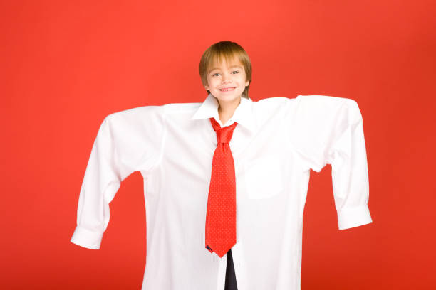 Boy wearing dads clothes stock photo