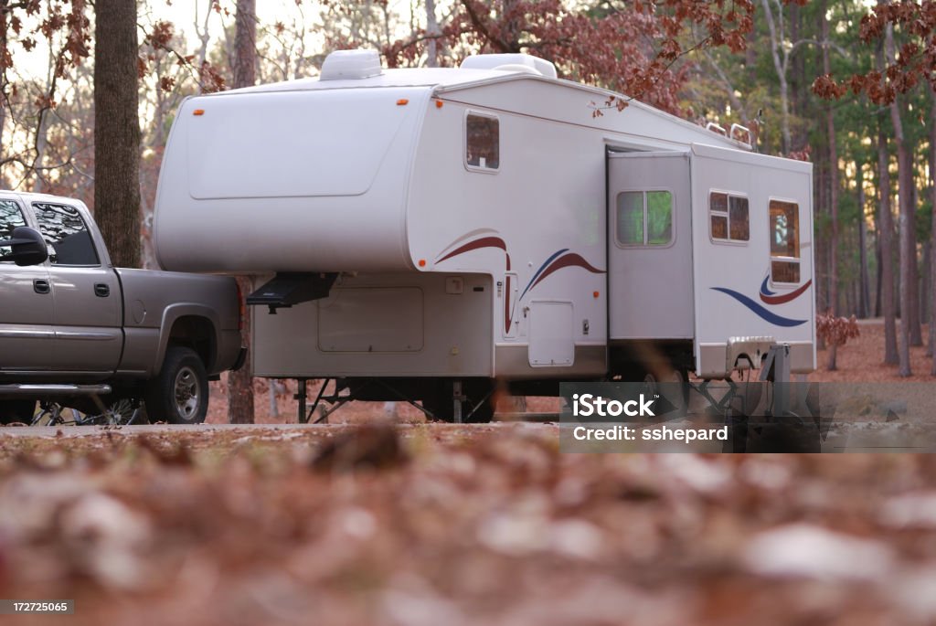 Fifth wheel at campsite Ground view of a fifth wheel camper trailer in a wooded campsite Number 5 Stock Photo