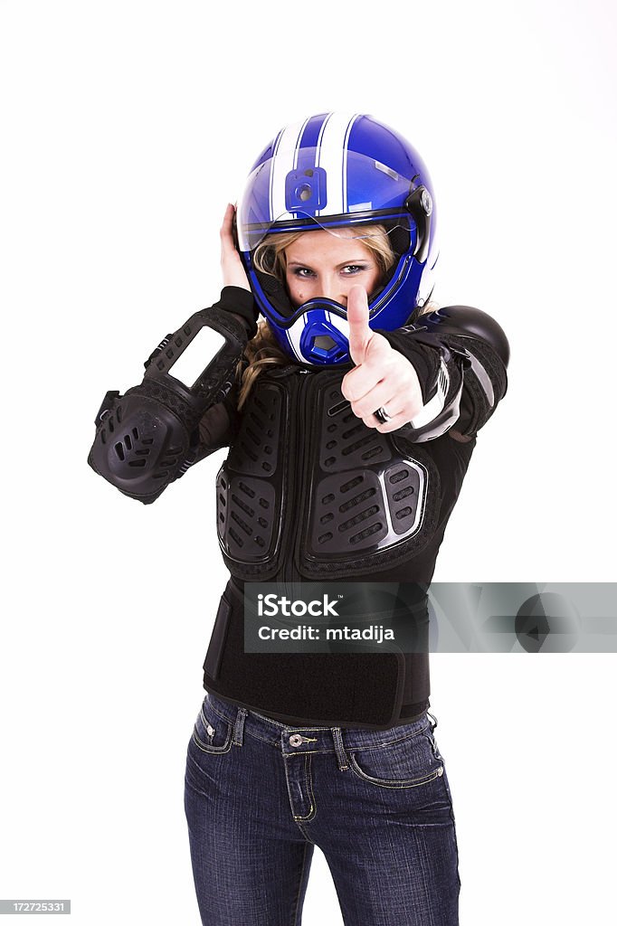 Joven hermosa mujer en motoracer uniforme - Foto de stock de Accesorio de cabeza libre de derechos