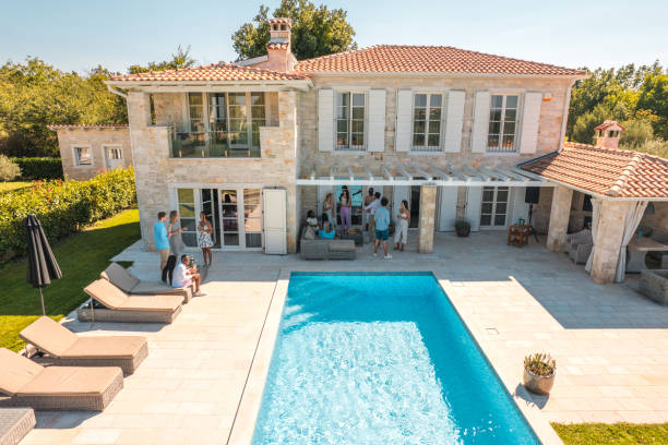 istock Sunny Villa Pool Party with Diverse Friends 1727267128