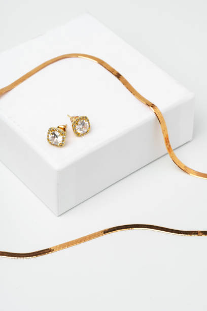 istock Golden diamond neacklace and earrings on white background 1727269218