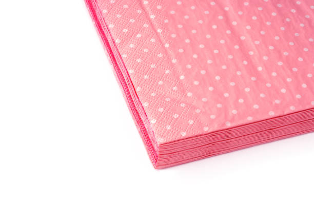 istock Stack of pink dotted paper napkins on white background 1727269228