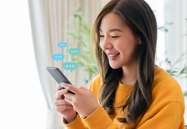 istock Adorable young Asian woman using mobile smartphone. Online live chat chatting on application communication digital media website and social network 1727269239