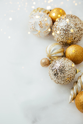 New Year and Christmas background. Christmas balls of golden and white color on a white background. Top view