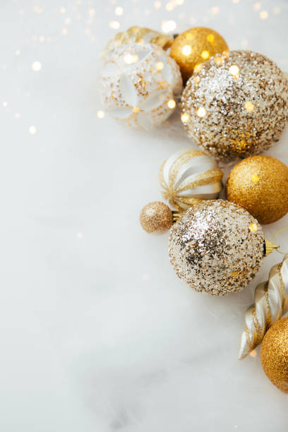 New Year and Christmas background. Christmas balls of golden and white color on a white background stock photo