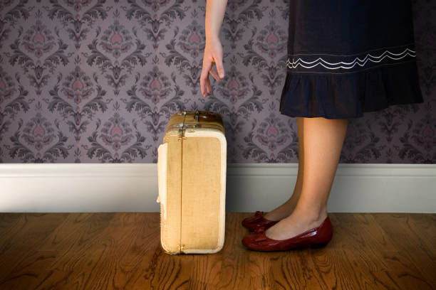 istock Woman picking up suitcase 172727580