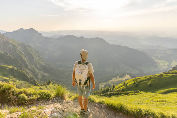 istock Hiker relaxes on sunny mountain ridge 1727278224