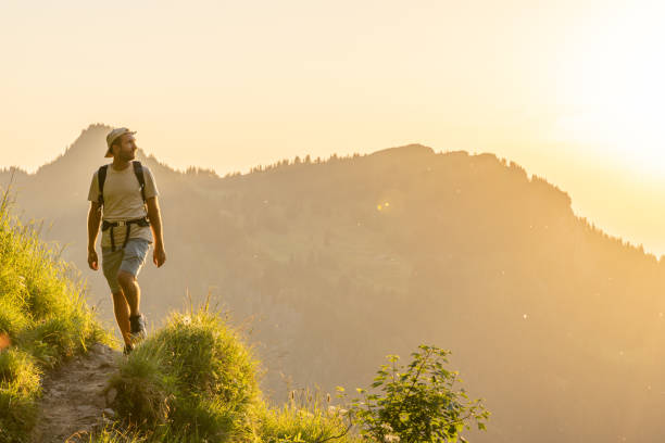 istock Hiker relaxes on sunny mountain ridge 1727280864