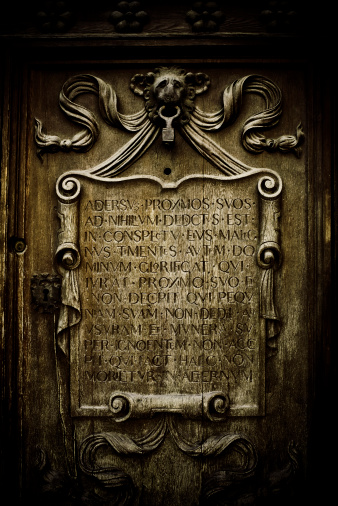 door detail with latin carvings in sevilla's ayuntamiento (city hall)